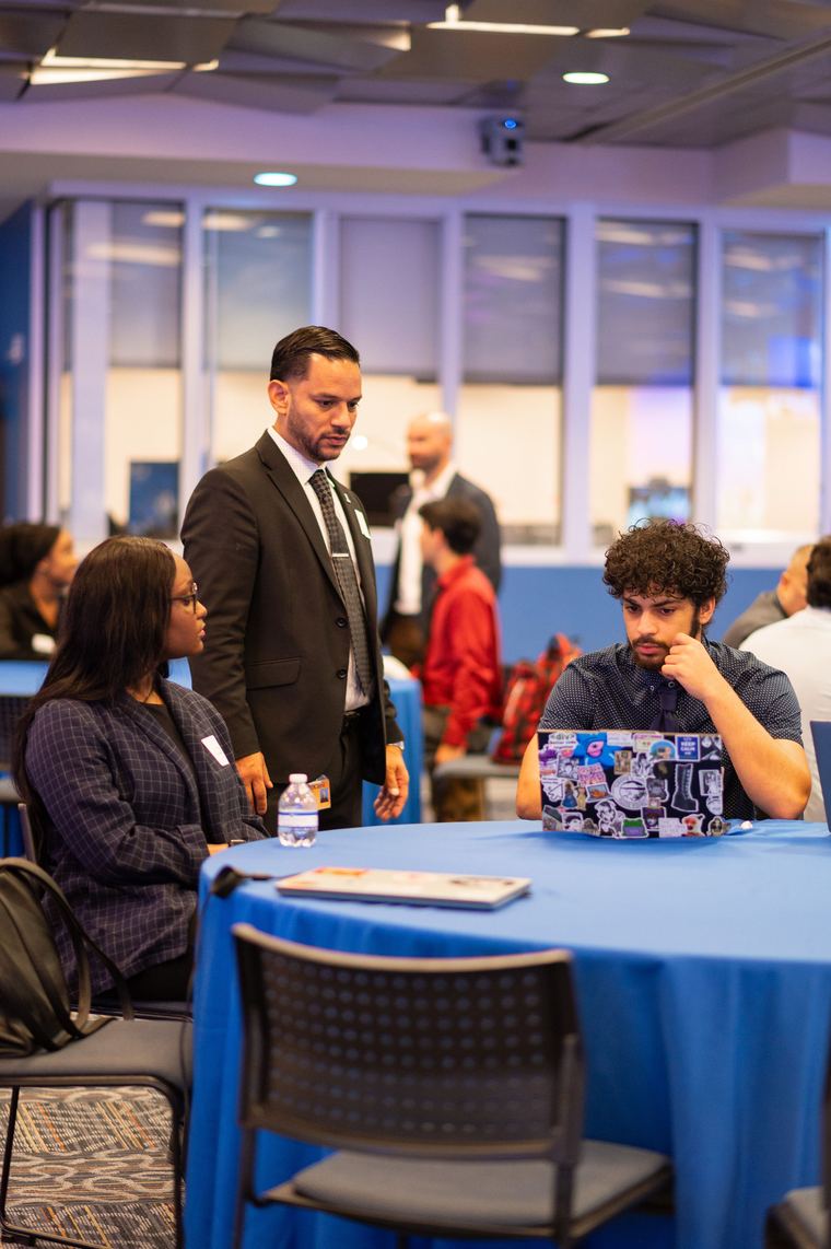 Employer mentoring students at the showcase